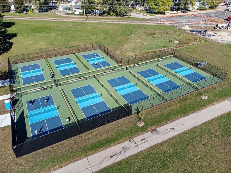 aerial view of a block of blue pickleball courts showing the painted line markings