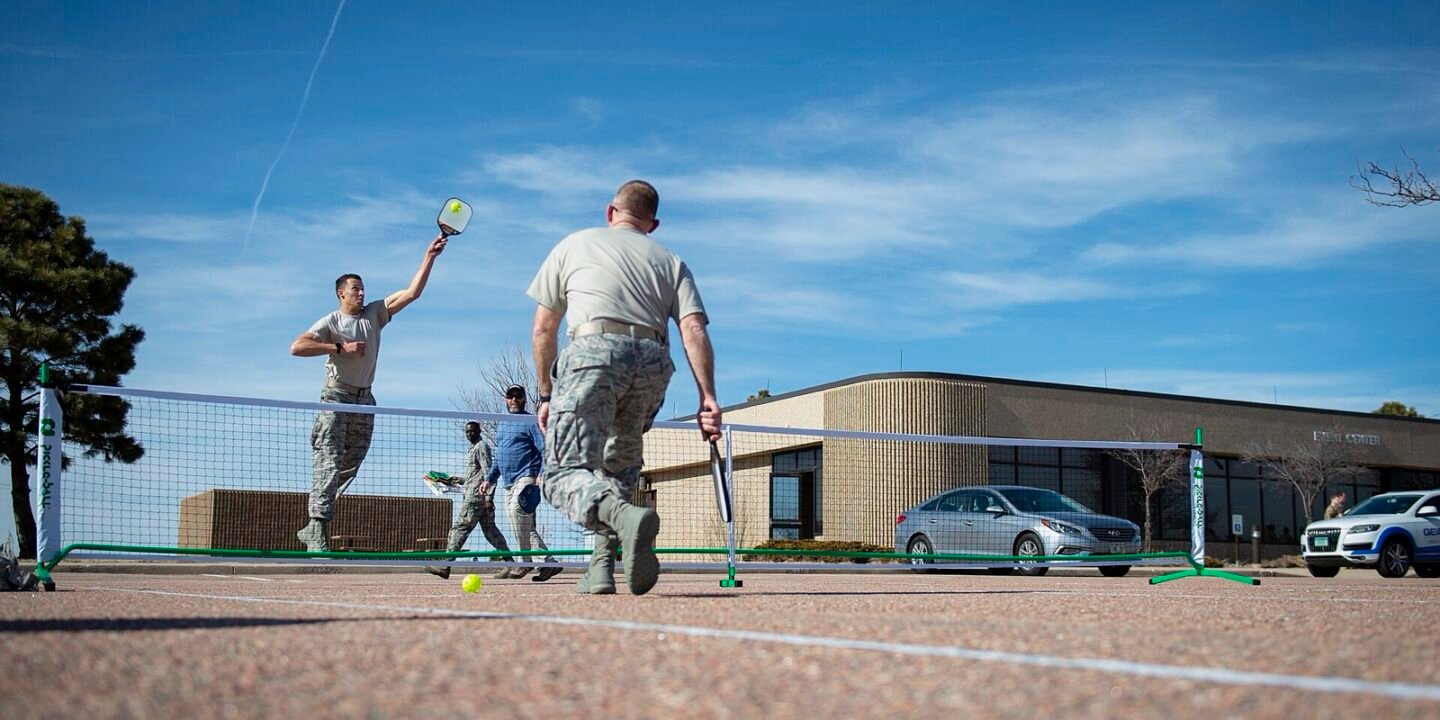 two players standing at the non-volley line trading soft dinks over the pickleball net