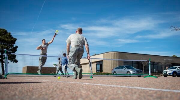 two players standing at the non-volley line trading soft dinks over the pickleball net