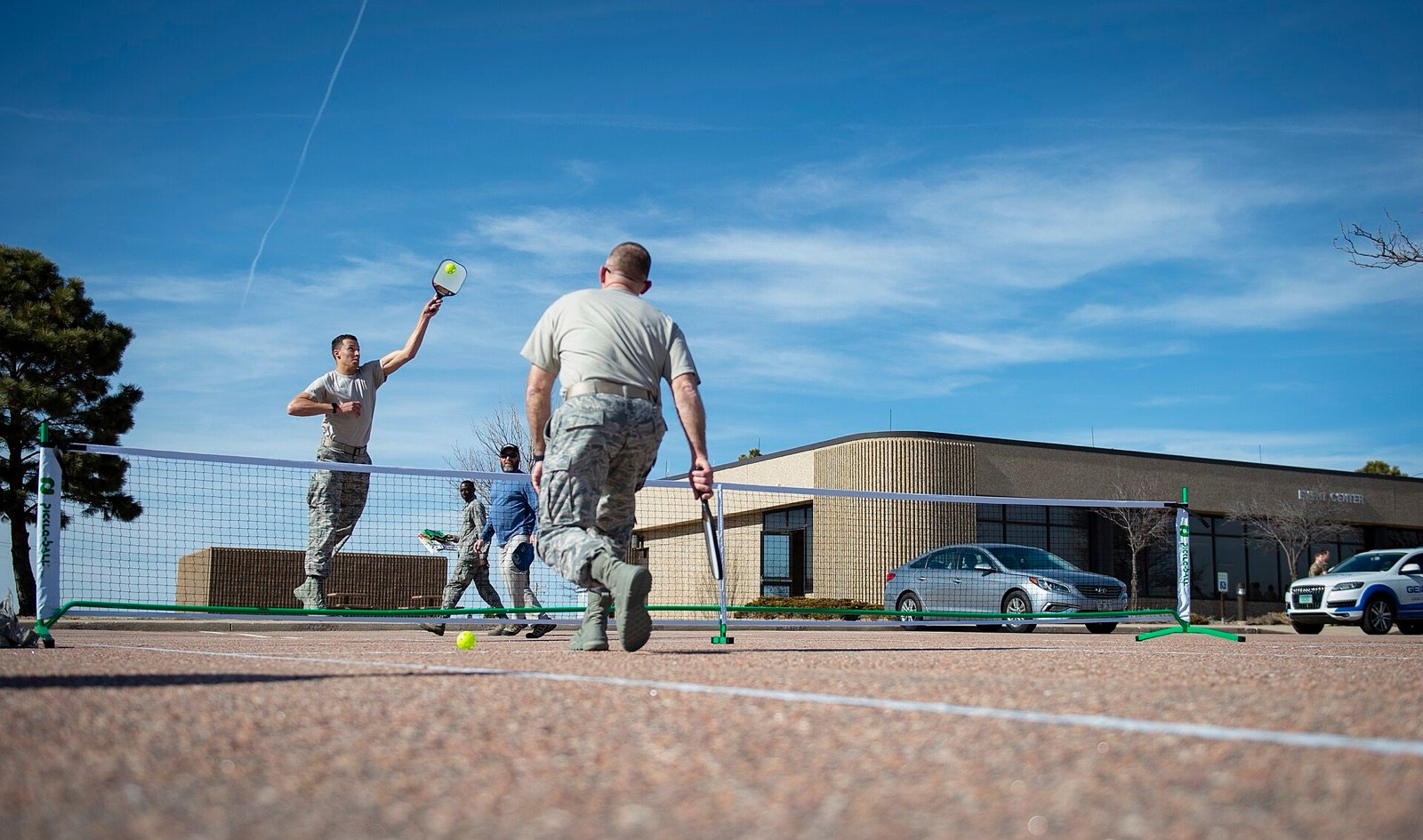 two players standing at the non-volley line trading soft dinks over the pickleball net