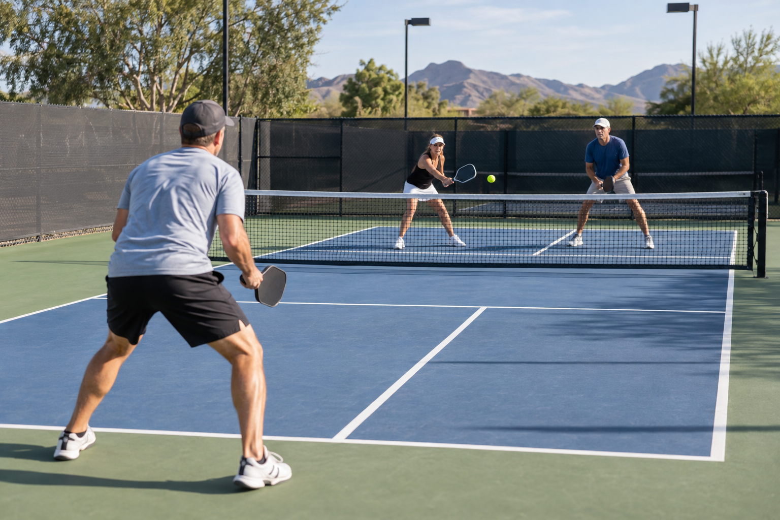 Pickleball mistakes: player standing too deep while opponents control the kitchen line